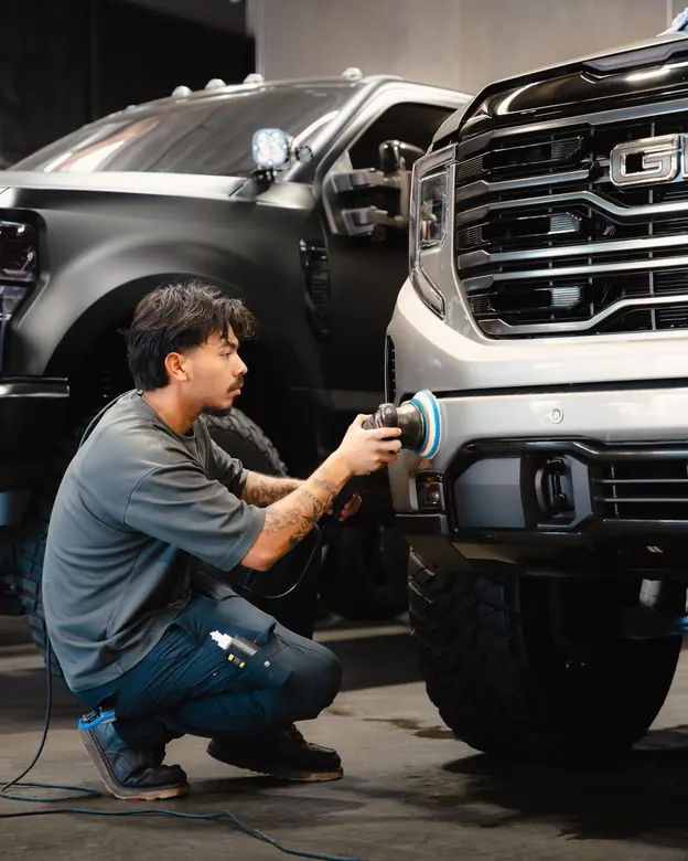 Marrufo Detailing team member machine-polishing a truck