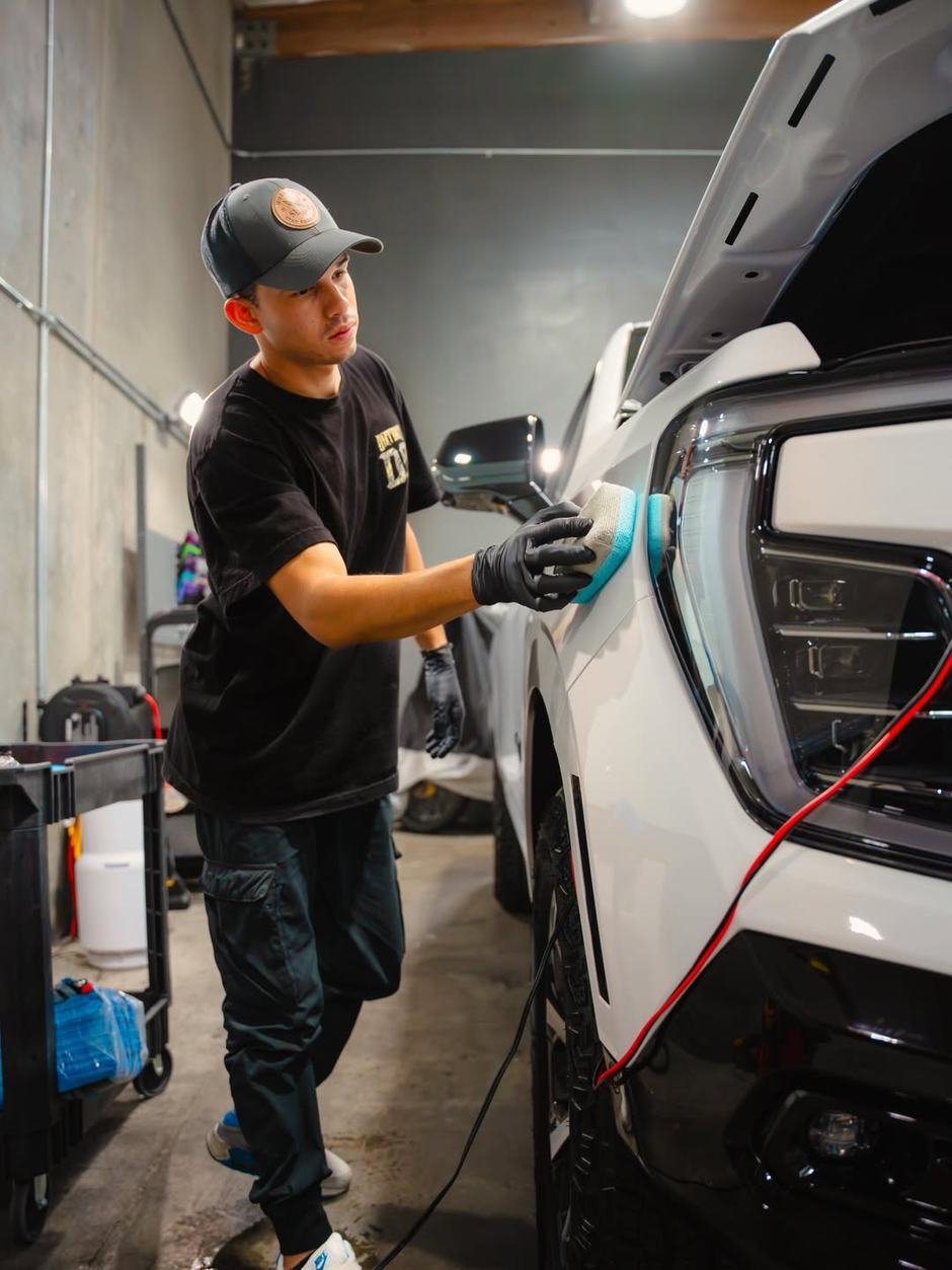 Detailer prepping and coating paint before sealing it in