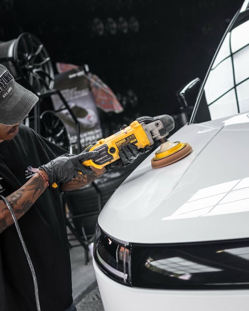 Machine polishing a glossy hood during a multi-stage paint correction
