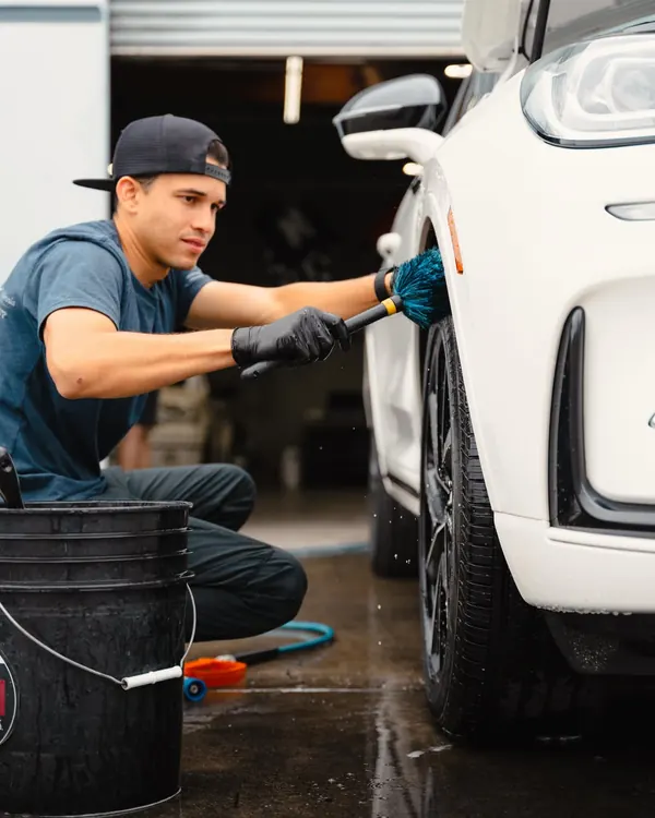 Marrufo detailer cleaning a wheel during a detail