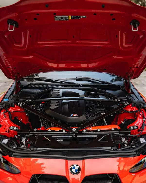 Detailed engine bay of a red BMW M4
