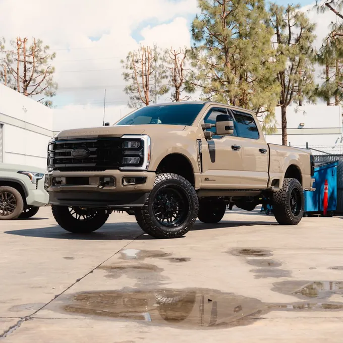 Lifted tan Ford Super Duty with a glossy finish