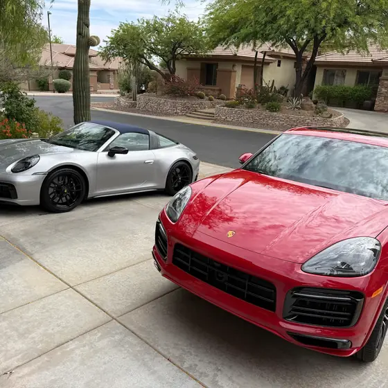 Detailed silver Porsche 911 Targa and red Porsche Cayenne, second angle