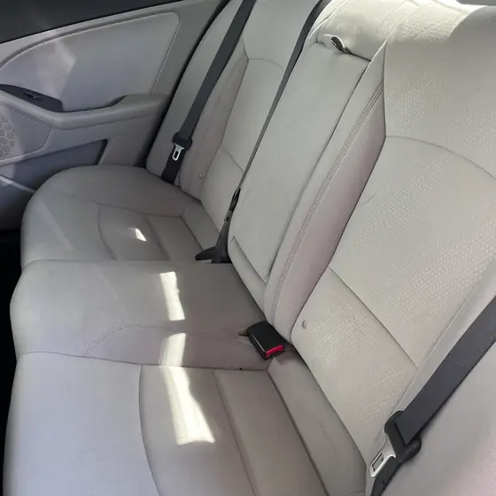 Spotless light-gray rear seats after an interior detail