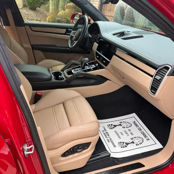 Red Porsche Cayenne GTS front interior in tan leather after detailing