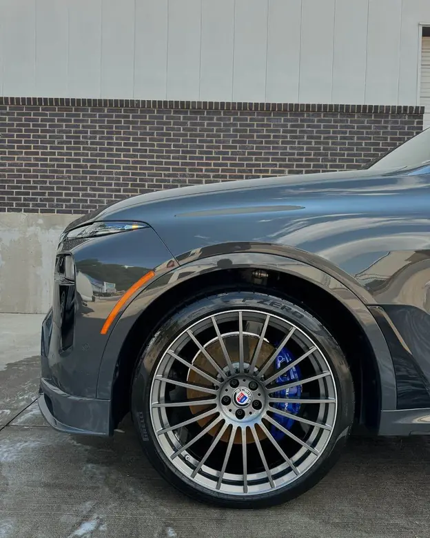BMW Alpina XB7 wheel with blue brake calipers, detailed
