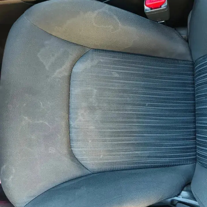 Cloth front seat before, with dirt and water stains