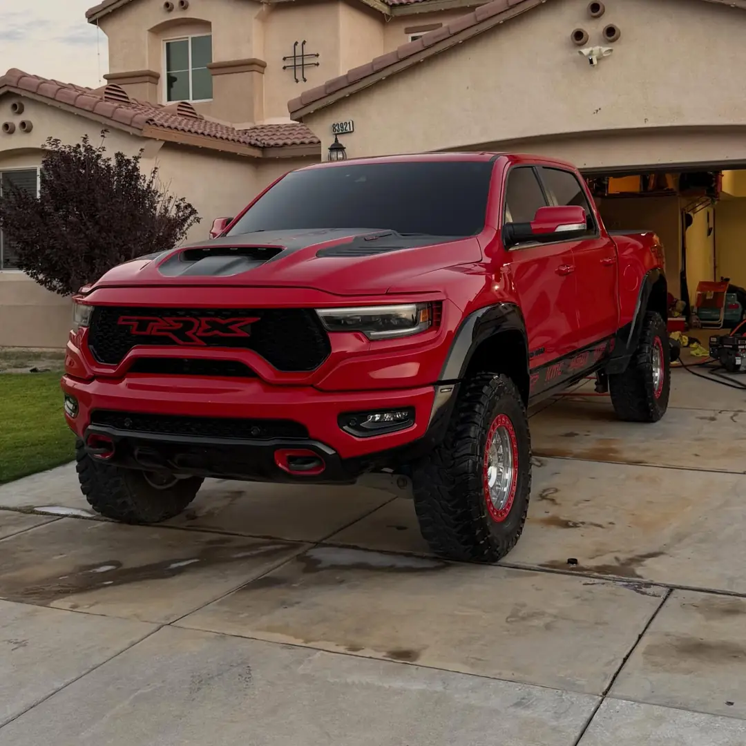 The same Ram TRX in the same driveway after the detail, clean and glossy