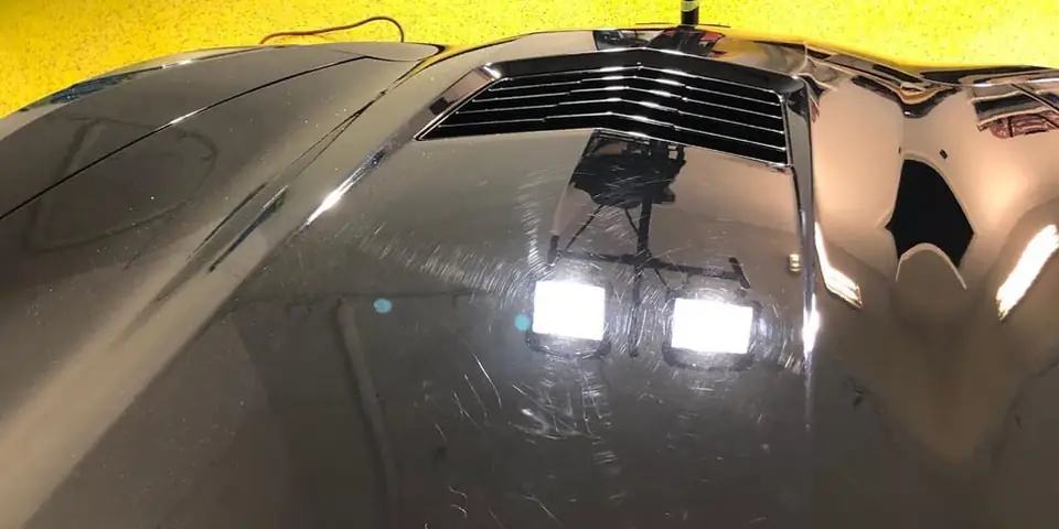 Black hood with swirls under lights