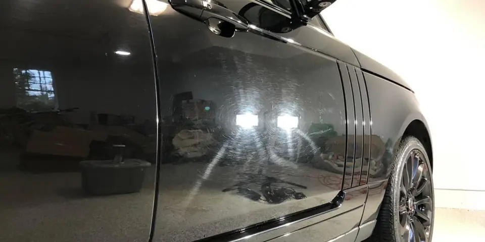Black door with swirl marks under lights