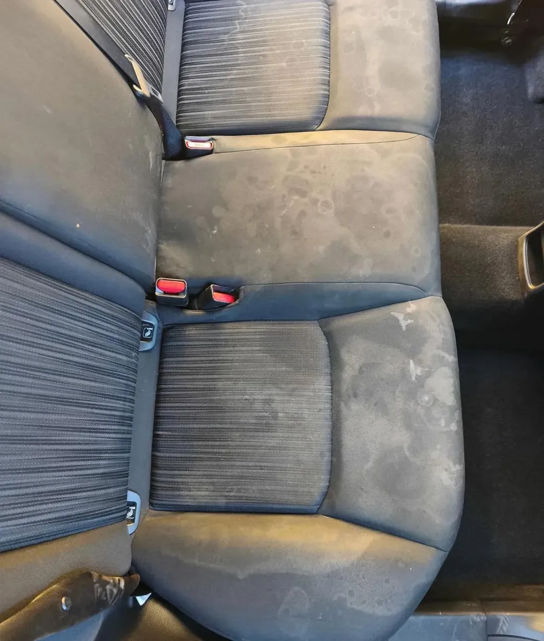 The same back seat before, covered in water stains