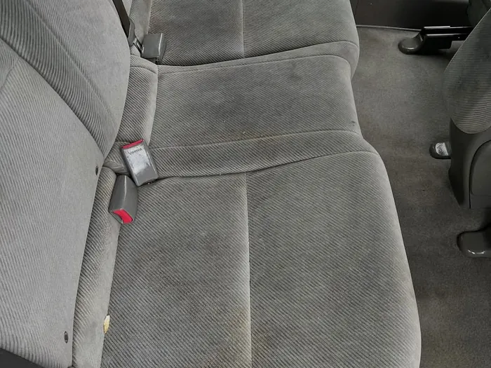 Gray cloth back seat before, dirty and spotted