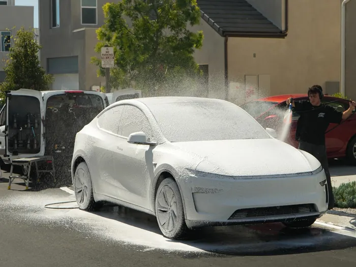 One of our detailers washing a Tesla Model Y