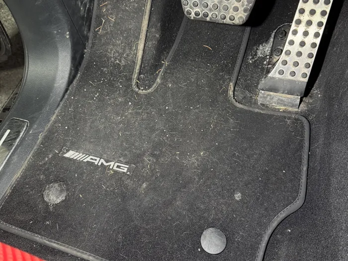 Driver floor mat before, dusty