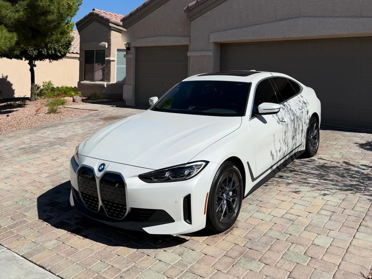 White BMW i4 after a full detail, parked in a paver driveway