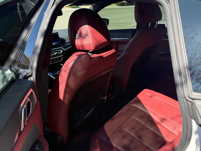 Red leather back seats in a BMW after a detail