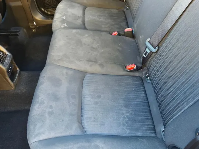 Cloth back seat before, stained