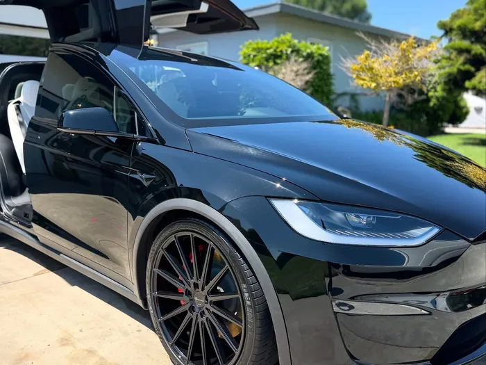 Black Tesla Model X with glossy paint after a detail