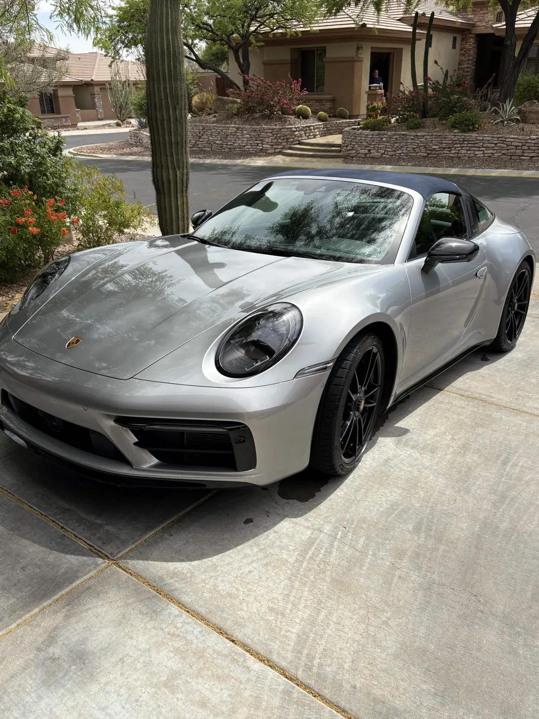 Silver Porsche 911 Targa, clean and glossy, parked in a driveway